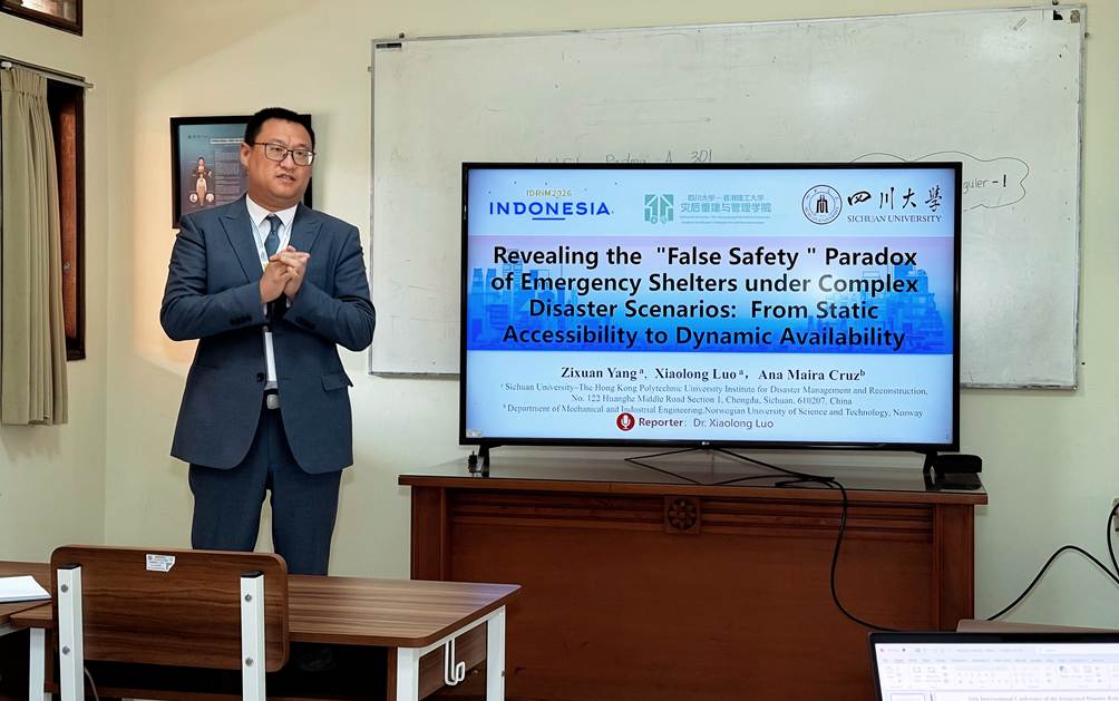 A person standing in front of a large screen Description automatically generated